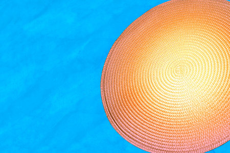 Yellow orange spiral around a straw background on blue turquoiseの写真素材