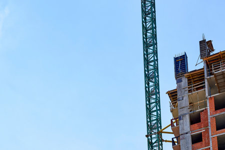Large construction high rise crane and clear blue skyの写真素材