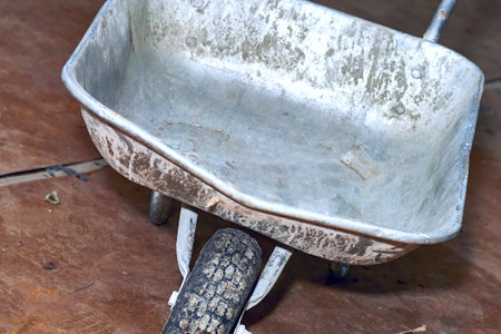 Construction metal wheelbarrow, various waste after repair