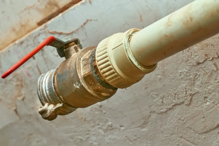 Plumbing. Sewerage. Water valve shutting off the water tap in the basementの写真素材