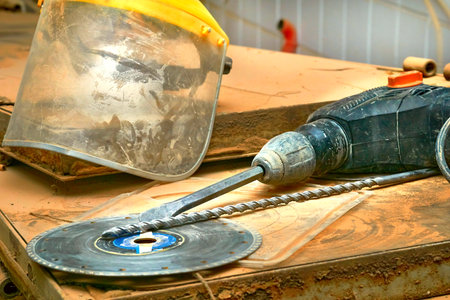 Rotary hammer drill, protective mask, saw blade,sheets of plywood,workshop