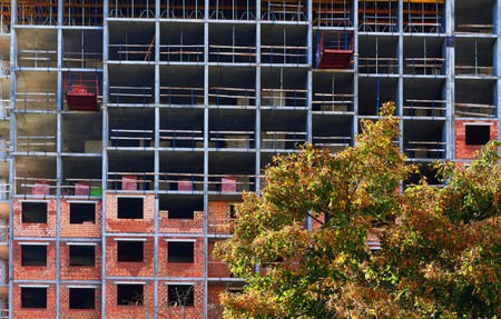 Construction of a brick multi storey building. Packing bricks on floors