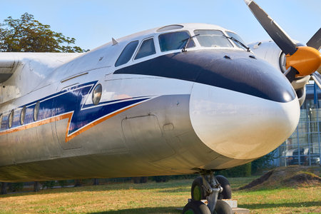 a close up view of the front of an airplane parked on the grass