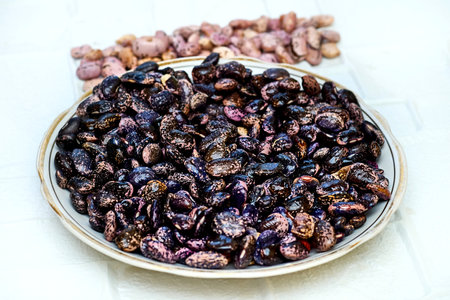 an edible seed, typically kidney shaped, growing in long pods on certain leguminous plants