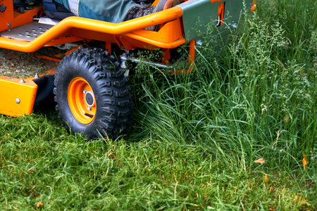 a handle electric or gasoline machine for cutting the grass on a lawn