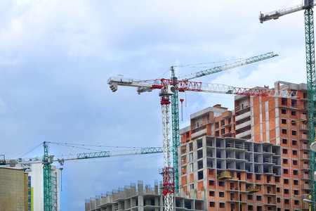 a large, tall machine used for moving heavy objects by suspending them from a projecting arm or beamの写真素材