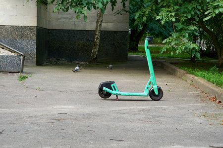 a light two wheeled open motor vehicle on which the driver sits over an enclosed engineの写真素材