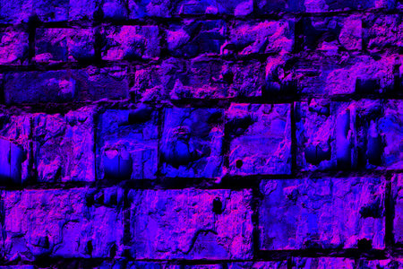 a continuous vertical brick or stone structure that encloses or divides an area of land