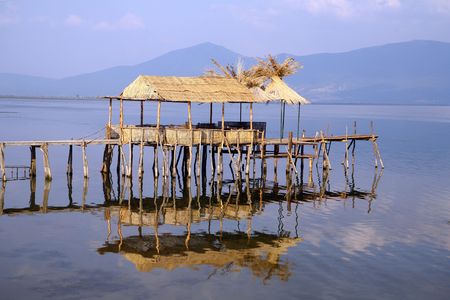 Fishermen`s village with houses made of cane and wooden docks in southern Europe.の写真素材
