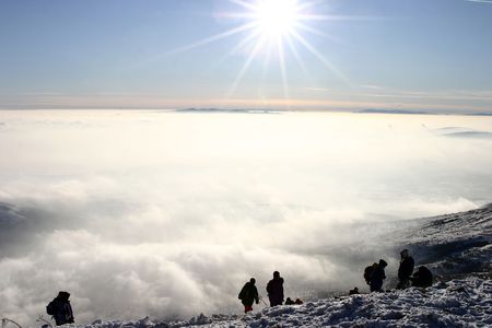 A group of mountin climbers above the clouds at mountainの写真素材