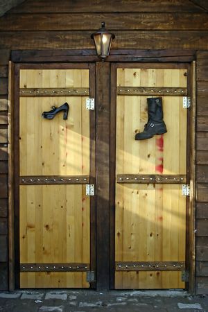 Wooden WC with funny symbols for man`s and woman`s cabin