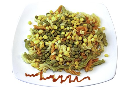 Mediterranean pasta with peas and sweet corn at the plateの写真素材