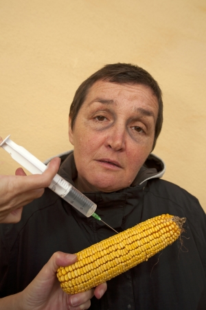 Genetically modified organism, ill woman with GMO cornの写真素材
