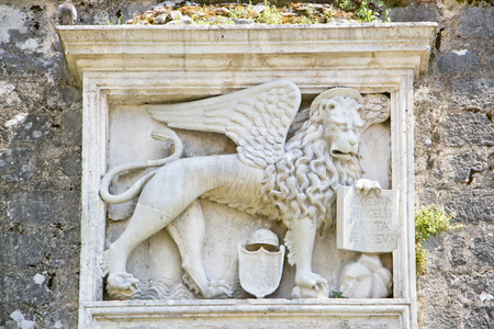 Montenegro - old medieval Mediterranean town - Venice lion with an open bookの写真素材