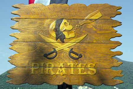 Pirate skull with bottle on wooden backgroundの写真素材