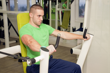 In the gym - man is exercising in the gymの写真素材