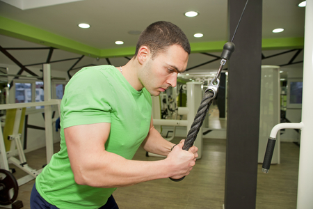 In the gym - man is exercising in the gymの写真素材