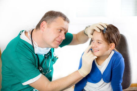 Eye doctor examining young girl patient Ophthalmologyの写真素材