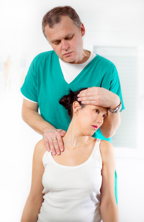 Chiropractor adjusting neck musclesの写真素材