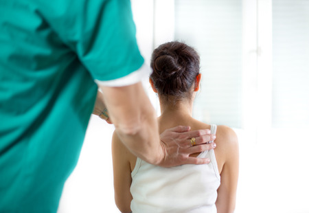 Chiropractor massage the female patient spine and backの写真素材