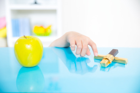 little girl with apple and chocolateの写真素材