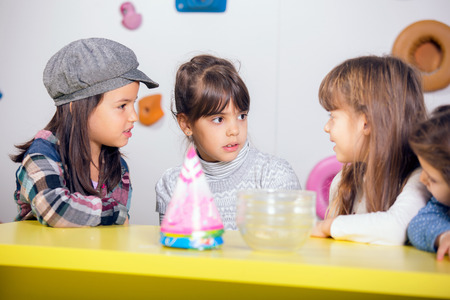 Little girls sitting and talking in the playroomの写真素材