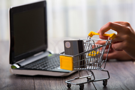 Hands pushing supermarket trolleys filled with credit hardの写真素材