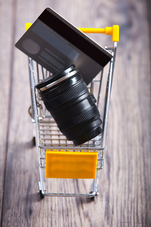 Lens camera shopping,lens and credit card in a shopping basketの写真素材