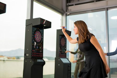 Young girls playing darts in a clubの写真素材