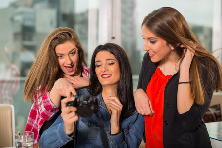 Teenager girls hanging out together in a coffee shopの写真素材