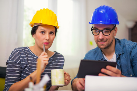 Team of architects working on a new project, using digital tabletの写真素材