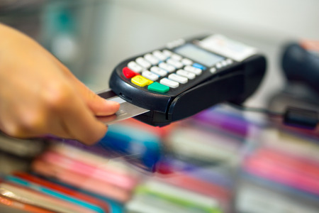 Female hand doing purchase through payment machineの写真素材