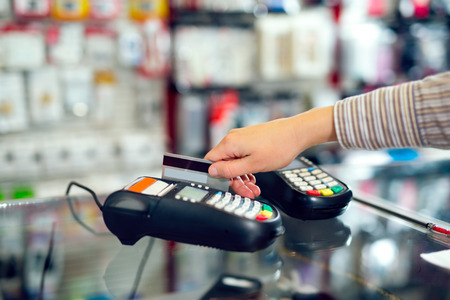 Female hand doing purchase through payment machine