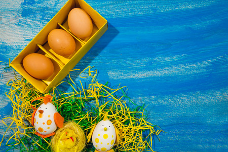 Easter motives on a blue wooden background, selective focus