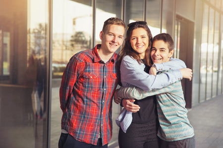 Happy teen girls and boys having good fun time outdoors. Selective focusの写真素材