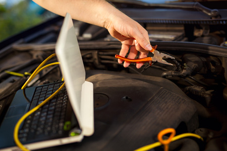 Car mechanic working in auto repair service.の写真素材
