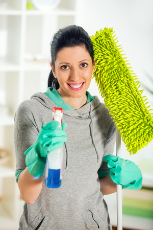Woman holding a cleaning spray in handの写真素材