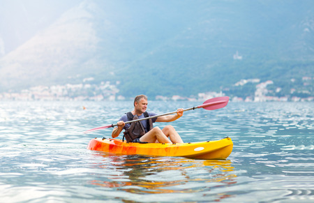 Mature man kayaking on the seaの写真素材