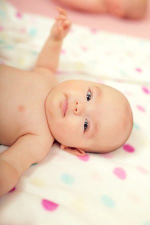Cute baby girl lying on her backの写真素材