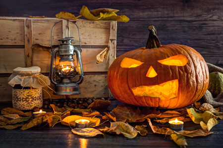 Halloween pumpkin head jack lantern with burning candlesの写真素材