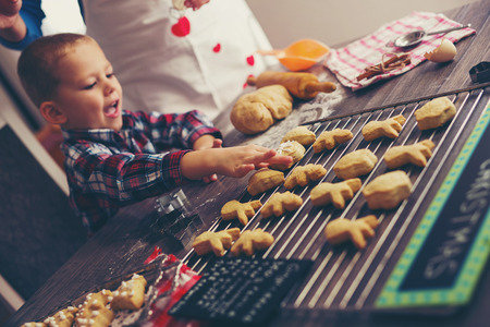 Little boy having fun in preparing Christmas cookiesの写真素材