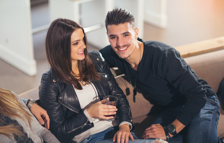 Young friends having a great time in restaurantの写真素材