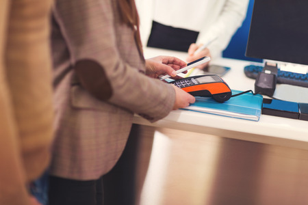 Woman using mobile phone to payの写真素材