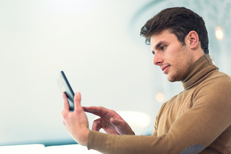 Portrait of happy businessman in office building holding digital tabletの写真素材