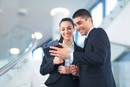 Portrait of business people working on a digital tabletの写真素材