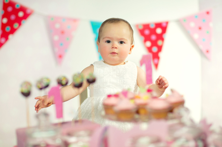 Beautiful happy baby on first birthday background.の写真素材