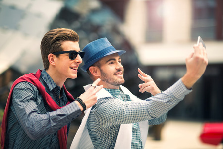 Males beautiful models outdoors make selfie photos, city style fashion
