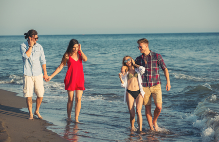Group of friends together on the beach having fun.の写真素材