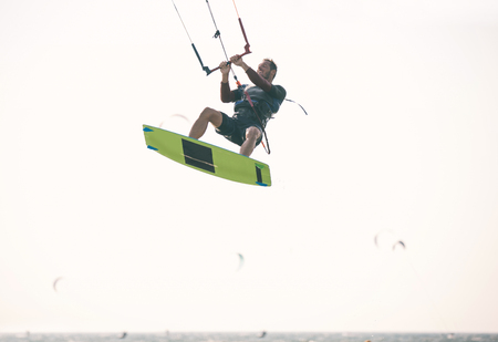Kiteboarder athlete performing kiteboarding kitesurfing tricks unhookedの写真素材