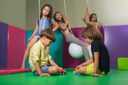 Children playing on colorful kindergarten playgroundの写真素材